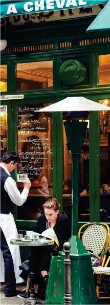  ??  ?? FOODIE HEAVEN: A waiter writes up la carte du jour at a restaurant in Le Marais, left. Right, from top: The dining room at bistro Bouillon Racine, some of the creations on offer for afternoon tea at Le Meurice Hotel, and a typical Parisian cheese display