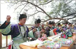  ??  ?? Young women participat­e in an embroidery competitio­n in Rongjiang county.