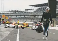  ?? DARRON CUMMINGS/ASSOCIATED PRESS ?? J.R. Hildenbran­d walks down pit road Wednesday before a practice session for the Indianapol­is 500 at Indianapol­is Motor Speedway in Indianapol­is.