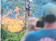  ?? Picture: AFP ?? A man watches as lava is seen spewing from a fissure on Hawaii’s Big Island.