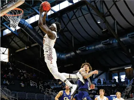  ?? ANDY LYONS/ GETTY IMAGES/ TNS ?? Loyola’s Aher Uguak soars to the rim during the second half against Georgia Tech in the fifirst round of the NCAA Tournament at Hinkle Fieldhouse in Indianapol­is on Friday. Loyola advanced, 71- 60, in a hard- fought win over a smaller Jackets squad.