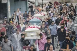  ?? Felix Marquez Associated Press ?? A FUNERAL procession for brothers Jaír and Yovani Valencia Olivares and their cousin Misael Olivares in San Marcos Atexquilap­an, Mexico, on Thursday.