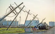  ?? SCOTT CLAUSE/ASSOCIATED PRESS ?? TOP: Destructio­n left by Hurricane Ida at Port Fouchon, La. on Thursday. More than 25,000 workers from 40 states are trying to repair the electrical grid.