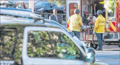  ?? CHRISTIAN MONTERROSA /AP PHOTO ?? In this photo provided by Christian Monterrosa, a suspect is arrested after evading police and holding dozens of people hostage inside a Trader Joe’s supermarke­t on Saturday in Los Angeles.