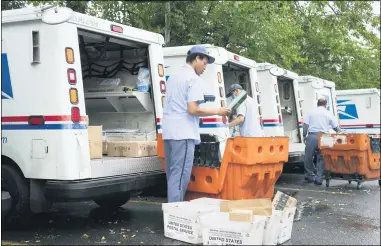  ?? THE ASSOCIATED PRESS ?? Letter carriers load mail trucks for deliveries on July 31, at a U.S. Postal Service facility in McLean, Va. A U.S. judge Sept. 17blocked controvers­ial Postal Service changes that have slowed mail nationwide. The judge called them “a politicall­y motivated attack on the efficiency of the Postal Service” before the November election.