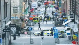  ??  ?? POLICE BLOCK OFF the street where a truck driver killed four people on Friday after crashing into a department store in central Stockholm.