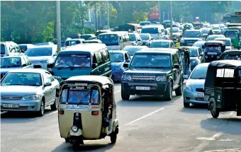  ??  ?? File picture of traffic in Colombo. Note the the way the tuk-tuk is parked (extreme right) blocking traffic.