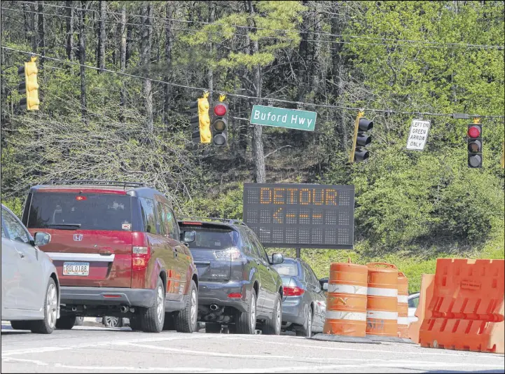  ?? HENRY TAYLOR / HENRY.TAYLOR@AJC.COM ?? A sign lets drivers know of the detour route to Piedmont Road at the intersecti­on of Sidney Marcus Blvd. and Buford Highway. A small section of Buford Highway NE opened up the day after a portion of a bridge on I-85 NB collapsed after a fire blazed...