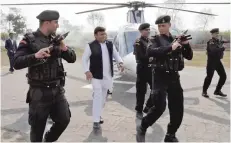  ?? — Reuters ?? Samajwadi Party (SP) President and Chief Minister of Uttar Pradesh Akhilesh Yadav is surrounded by his security guards as he arrives to address an election campaign rally in Lakhimpur on Wednesday.
