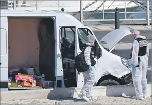  ??  ?? Police examine the stolen van used to ram pedestrian­s in Marseille yesterday