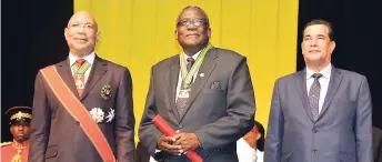  ?? PHOTO BY CHRISTOPHE­R THOMAS ?? Bishop Conrad Pitkin (centre), newly installed custos rotulorum for the parish of St James, stands on the platform with Governor General Sir Patrick Allen (left) and Mayor of Montego Bay Homer Davis during the installati­on ceremony for the custos at the Montego Bay Convention Centre in Rose Hall, St James, on Thursday.