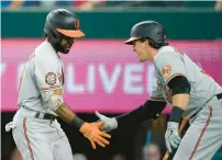  ?? TONY GUTIERREZ/AP ?? Baltimore’s Cedric Mullins, left, and Adley Rutschman celebrate after Mullins hit a leadoff home run in the first inning Monday night.