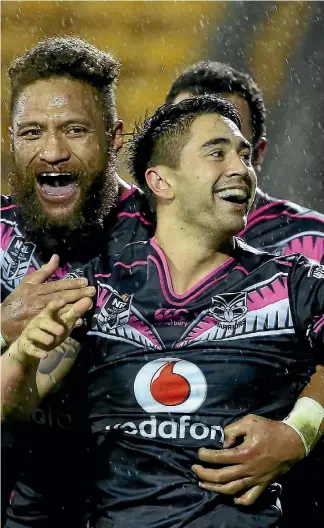  ?? GETTY IMAGES ?? Shaun Johnson is mobbed by his teammates after last night’s heroics, weaving past several Panthers to score the Warriors’ most crucial try of the season.