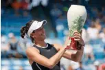  ?? Associated Press ?? n Garbine Muguruza, of Spain, holds the Rookwood Cup after defeating Simona Halep, of Romania, in the women's singles final at the Western & Southern Open on Sunday in Mason, Ohio.