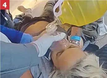  ?? ?? ‘Halyna, stay with us’: Oxygen mask is placed on the mortally wounded Hutchins