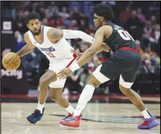  ?? Associated Press ?? Clippers forward Paul George (13) dribbles the ball around Portland Trail Blazers guard Scoot Henderson during the second half on Wednesday in Portland, Ore.