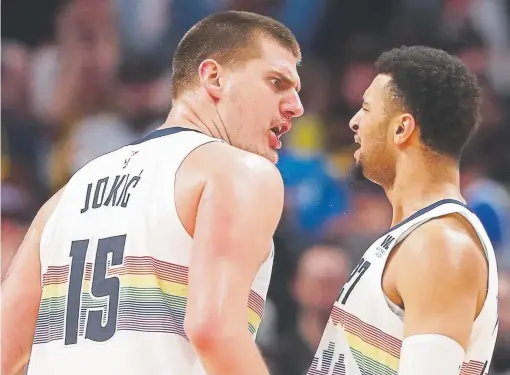  ?? Matthew Stockman, Getty Images ?? Nuggets center Nikola Jokic, left, and guard Jamal Murray celebrate during the fourth quarter Sunday night at the Pepsi Center in a game against the Portland Trail Blazers. Jokic had 40 points, 10 rebounds and eight assists. Murray scored 24 points.