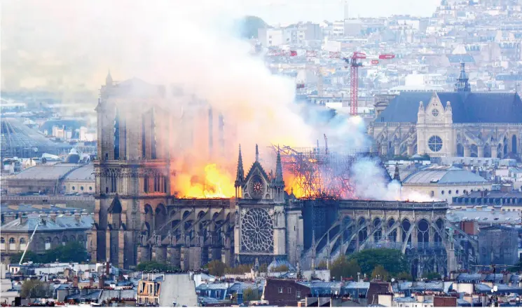  ?? Hubert HITIER / AFP / GETTY IMAGES ?? Flames rise during a fire at the landmark Notre Dame cathedral in central Paris on Monday, potentiall­y involving renovation­s being carried out at the site, the fire service said.