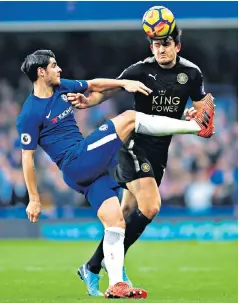  ??  ?? High intensity: Harry Maguire heads the ball under pressure from Alvaro Morata