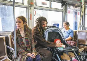  ?? Photos by Gabrielle Lurie / The Chronicle ?? Marielle Lowes, 24, and Paul Wassell ride the bus with their 8-month-old son, Donovan Wassell, after their recreation­al vehicle, shown below, was towed.