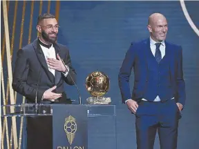  ?? ?? ABOVE: Karim Benzema accepts the 2022 Ballon d'Or award alongside Zinedine Zidane, who was the last French player to win the accolade in 1998.