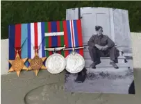  ??  ?? Centre left: Medals belonging to Lance Corporal Murray Northrup, seen in the photograph, rest on his gravestone at the Canadian War Cemetery at Bergen op Zoom, Netherland­s. Northrup was killed on October 30, 1944, during the Battle of Walcheren Causeway.