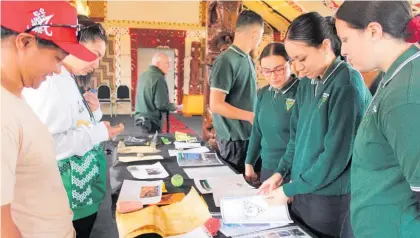  ?? ?? Current students view the contents of the time capsule buried 30 years ago.