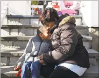  ?? Tyler Sizemore / Hearst Connecticu­t Media ?? Tonya Gonsalves embraces her adopted child SeanMichae­l, 5, at their home in Westport on Monday.