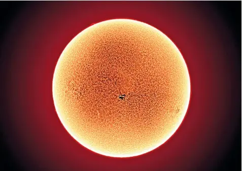  ??  ?? Brendan Owens with the AMAT telescope at the Royal Observator­y at Greenwich, which was capable of capturing this incredible image of activity on the Sun