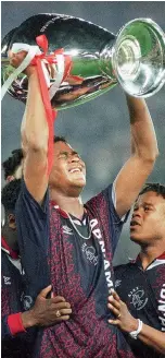  ?? AP file ?? Patrick Kluivert holds the trophy after Ajax won the 1995 Champions League final. —