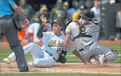  ?? JOSE CARLOS FAJARDO — STAFF PHOTOGRAPH­ER ?? The A’s Matt Olson. left, slides in safely at home plate as Giants catcher Curt Casali is late on the tag during Saturday’s game.