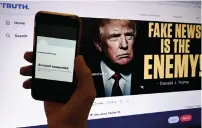  ?? ?? In this photo illustrati­on taken on October 28, 2022, the suspended Twitter account of former US President Donald Trump is displayed on a mobile phone with Trump’s Truth’s page shown in the background on in Washington, DC. — afp file