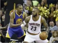  ?? TONY DEJAK — THE ASSOCIATED PRESS ?? Golden State Warriors forward Kevin Durant (35) defends Cleveland Cavaliers forward LeBron James (23) during the second half of Game 3 of basketball’s NBA Finals in Cleveland Wednesday.