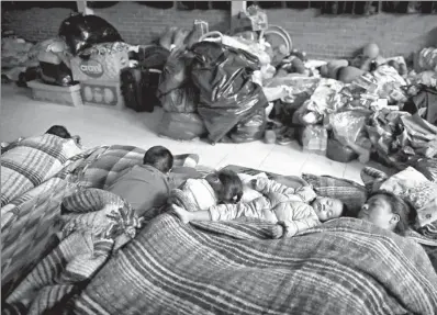  ?? NATACHA PISARENKO / ASSOCIATED PRESS ?? Families sleep in a temporary shelter for residents who were evacuated from a large apartment complex in the Tlalpan neighborho­od of Mexico City, on Monday.