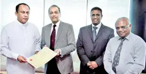  ??  ?? Investment Promotion Minister Lakshman Yapa Abeywardan­a handing over the BoI Certificat­e of Registrati­on to Hemas Holdings PLC Group Director Abbas Esufally in the presence of Serendib Leisure Hotels Managing Director Ranil de Silva and Anantara...