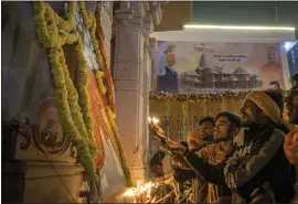  ?? ATUL LOKE — THE NEW YORK TIMES ?? Praying is seen outside the Ram Temple in Ayodhya, India, after an opening ceremony Jan. 22. The grand opening of a temple in Ayodhya was both a religious ritual and a madefor-TV spectacle for a broadcast media co-opted by Prime Minister Narendra Modi.