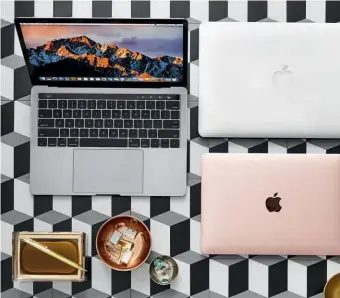  ??  ?? Apple puts on a pretty face, but technology is at its core (no pun intended). The latest MacBook Pro with Touch Bar boasts up to 32GB of memory, improved display and faster processing.