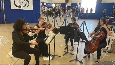  ?? RECORDER PHOTO BY CHARLES WHISNAND ?? From left, Harmony Magnet Academy students Yajari Aguilar, Sara Mitchell, Isabel Burrough and Cambria Rohrbach perform at the Portervill­e Unified School District Pathways Expo on Thursday.