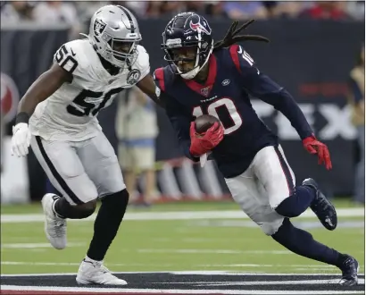  ?? MICHAEL WYKE — THE ASSOCIATED PRESS ?? Houston wideout DeAndre Hopkins, who gave the Raiders fits in Sunday’s game, runs around Raiders linebacker Nicholas Morrow.