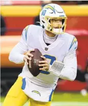  ?? REED HOFFMANN AP ?? Justin Herbert’s developmen­t will be a key factor in the hire of the next Chargers head coach.