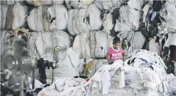  ?? Sarah Dea / The National ?? Workers process waste fabric at a recycling plant in Sharjah