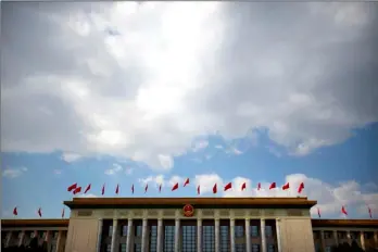  ??  ?? Clouds move across the sky over the Great Hall of the People in Beijing during the opening session of China’s annual National People’s Congress on Sunday in Beijing’s Great Hall of the People. AP PHOTO