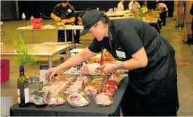  ??  ?? Apprentice Butcher of the Year Cherise Redden putting the final touches on her display.