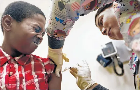  ?? Genaro Molina Los Angeles Times ?? DESMOND SEWELL, 12, receives a vaccinatio­n from medical assistant Jessica Reyes at Lou Colen Children’s Health and Wellness Center in Mar Vista on Aug. 4.