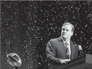  ?? Charlie Riedel/Associated Press ?? NFL commission­er Roger Goodell looks at artificial snow falling on stage as he speaks at a news conference Friday in New York.