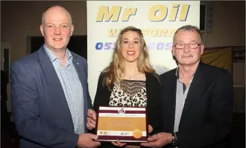  ??  ?? Fiona Kehoe, national Novice cross-country champion and Mr Oil athlete of the month for December, produced a superb display in the National Indoor Arena on Sunday. She is pictured with Ciarán Mooney (left) and Paddy Morgan (right) at Friday’s county...