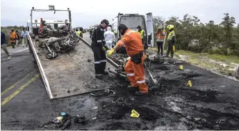  ?? — AFP photo ?? A handout picture released by the Gobernacio­n de Magdalena shows a firefighte­r removing the remains of a tanker truck carrying fuel that caught fire, in Pueblo Viejo, north of Bogota, Colombia.