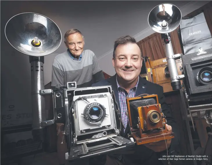  ??  ?? John and Bill Stephenson of Beattie's Studio with a selection of their large format cameras at Dodges Ferry.