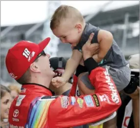  ?? DARRON CUMMINGS — THE ASSOCIATED PRESS ?? Kyle Busch celebrates with his son, Brexton, after winning the pole in Indianapol­is Saturday.