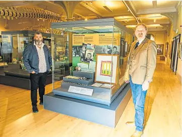  ??  ?? CITY’S LINK: MP Chris Law views his Nelson Mandela-related exhibits along with Billy Gartley, head of cultural services for Leisure and Culture Dundee. Picture by Steve Brown.